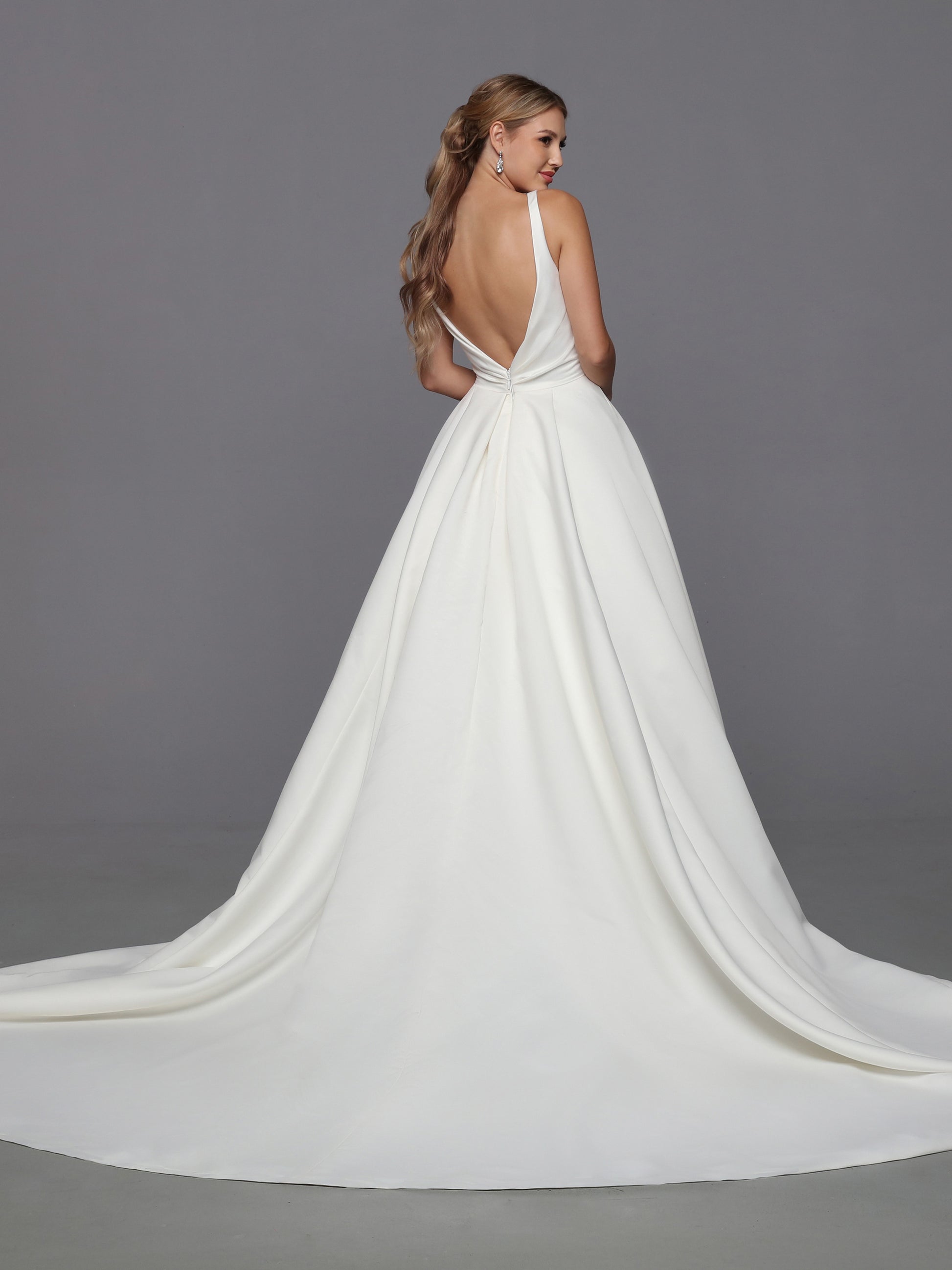 DaVinci Bridal 50766 A-Line Ballgown Satin Open Back Pockets Bow Train Wedding Gown. This feminine satin ball gown features lovely on-trend updates. The faux-wrap bodice has a waist-deep V-back accented with a removable oversized bow.