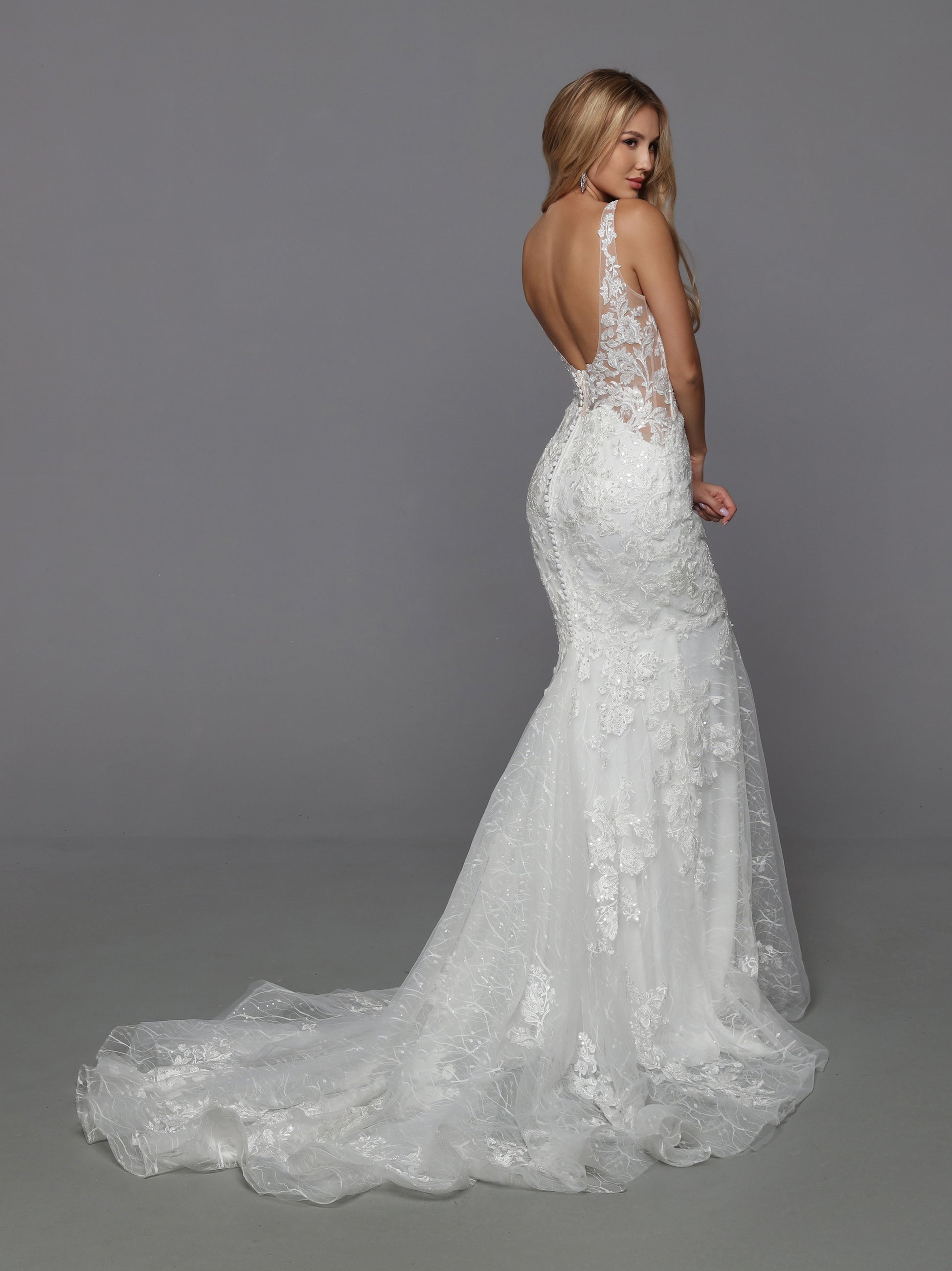 DaVinci Bridal 50770 Mermaid Fit And Flare V-Neck Lace Tulle Open Back Train Wedding Gown. This tempting slip dress has all the details you love. A sheer bodice covered with beaded lace applique, side cutouts, and a deep scoop back. A sheer textured lace skirt embellished with matching applique. And the finishing touch of a row of covered buttons running from the back waistline to the chapel train.
