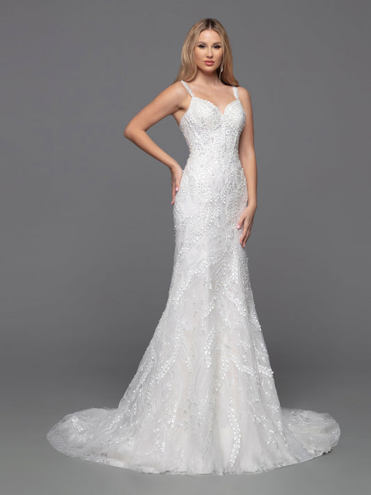 The David Bridal 50805 Draped Beaded Lace Shimmer Fitted Wedding Dress is the essence of elegance. Crafted from intricate beaded tulle and featuring sheer beaded straps and a corset back, this timeless fit and flare sheath exudes classic sophistication.  Sizes: 2-20  Colors: Ivory/Blush, Ivory/Ivory