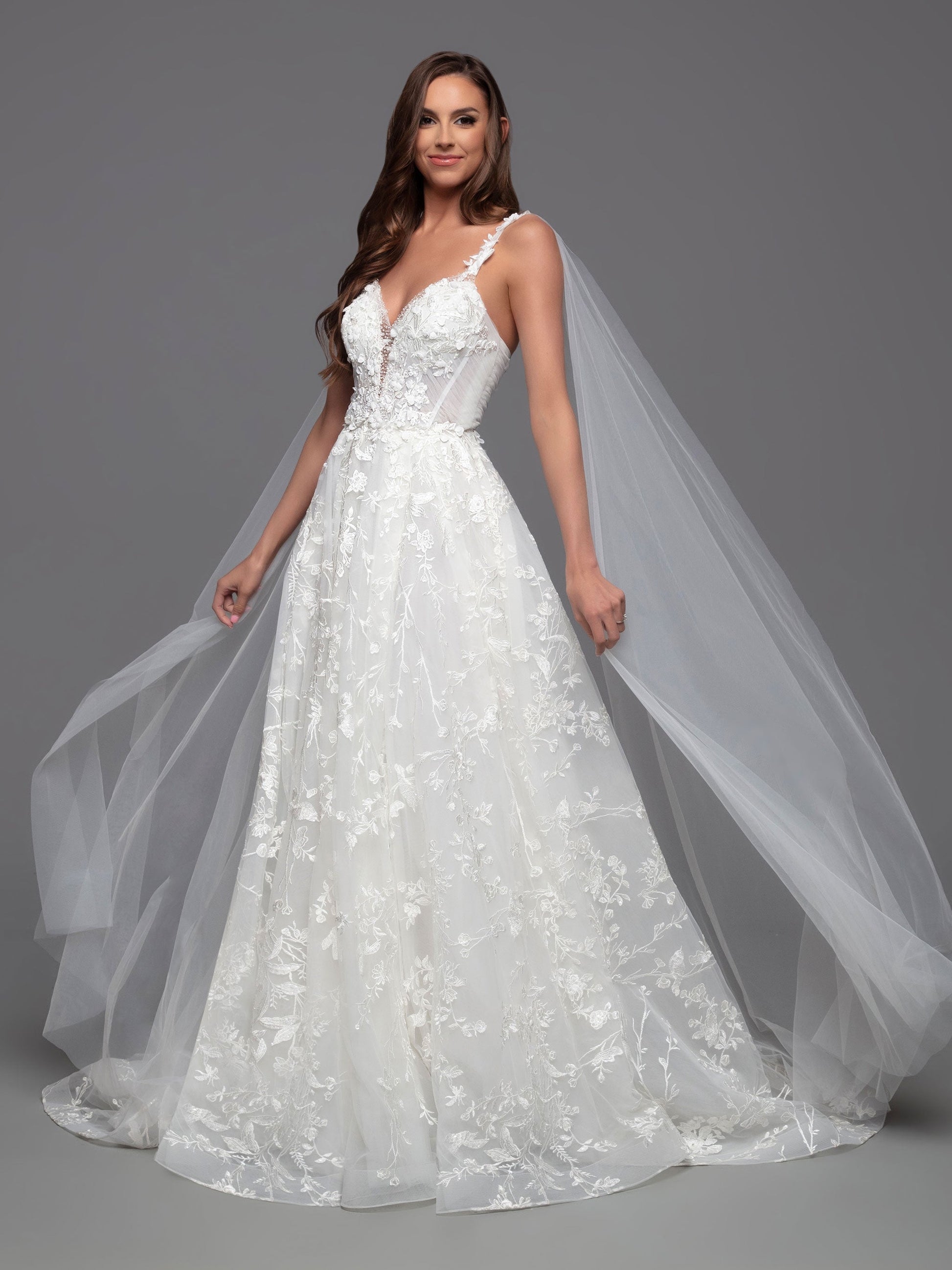 Look stunning on your special day in this Davinci Bridal 50806 A Line Lace Cape Wedding Dress. Constructed with a sheer crystal plunging neckline and 3D floral embroidery on the front and back bodice, this gown provides an exquisite look with gathered skirt and chapel train. Plus, you can customize your look and stand out in photos with the addition of the detachable veil wings.  Sizes: 2-20  Colors: Ivory