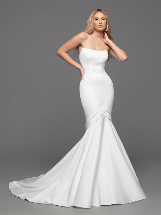 Davinci Bridal Gown 50816 size 12 Ivory Long Fitted Mermaid Wedding Dress Pointed strapless Experience an unforgettable wedding day with this luxurious bridal gown from Davinci. Crafted from alluring ivory fabric, this fit-and-flare mermaid gown is perfected with a strapless, straight-across neckline, a modest silhouette, and an open back with interesting button details and a zipper fastening. The chapel train adds a truly elegant touch.  Size: 12  Color: Ivory 