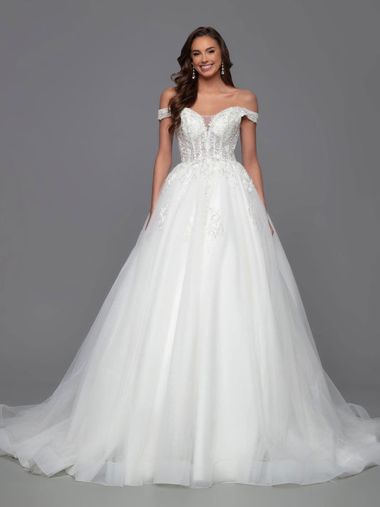 This classic, A-Line ballgown by Davinci Bridal is the perfect combination of timeless elegance and modern touches. The shimmer sheer, off-the-shoulder bodice offers a unique, contemporary look, while the layered tulle skirt features scattered lace accents and a chapel train for a traditional, timeless feel. A corset back ensures a perfect fit.  Sizes: 2-20  Colors: Ivory
