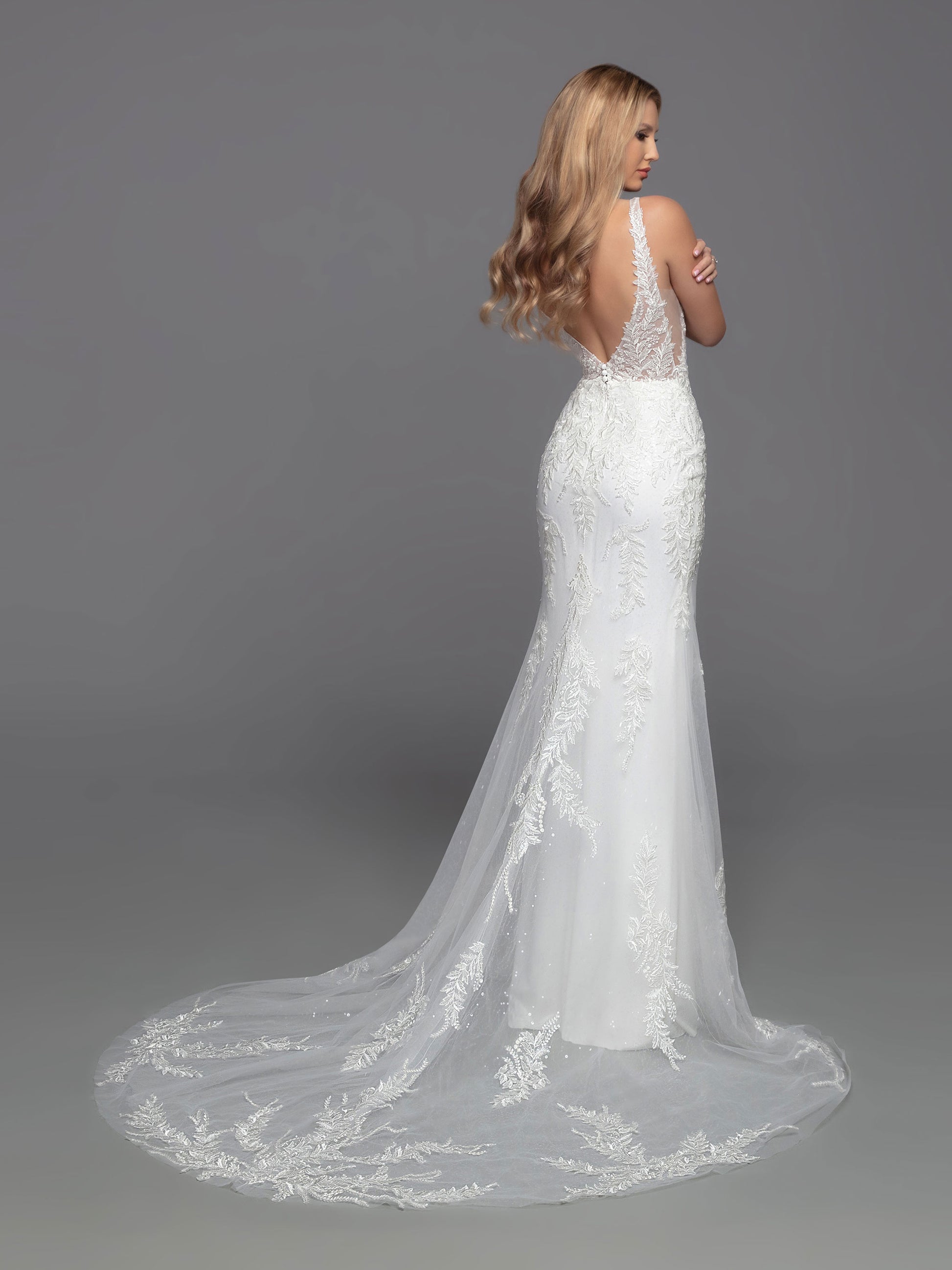This Davinci Bridal 50822 wedding dress offers an alluring mix of modern elegance and classic sophistication. The sheer lace bodice is perfectly complemented by the beaded sequin and lace applique accents on the floor-length skirt lining and sheer chapel train. The deep V-neck & back and sheer side panels flatter any figure. Make an unforgettable statement on your special day.  Sizes: 2-20  Colors: Ivory