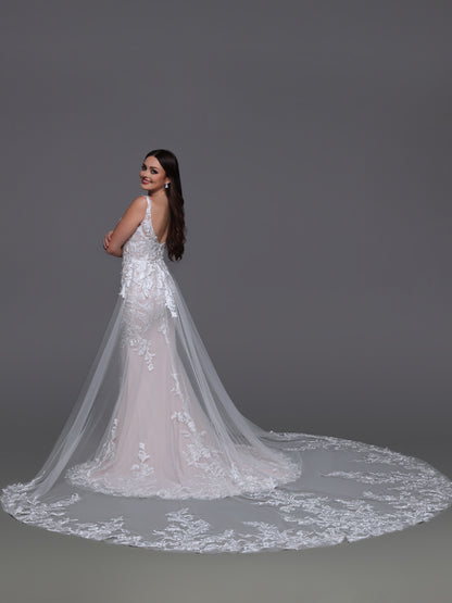 Elevate your bridal elegance with the Davinci Bridal 50927 gown in size 10. This ivory lace dress features a graceful V-neckline and a delicate tulle overskirt, blending classic romance with modern sophistication. Perfect for the bride seeking timeless beauty and refined detail on her special day.

Fabric:&nbsp;Lace, Tulle

Neckline:&nbsp;Modest, Straps, V-Neck

Silhouette:&nbsp;Fit &amp; Flare

Details:&nbsp;Back Interest, Beading, Buttons, Cap Sleeves, Chapel Train, Lace, Lace Applique, Modest, Removeable