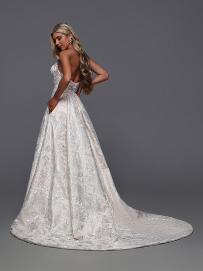 Elevate your bridal look with the Davinci Bridal 50936, a strapless gown in stunning rose gold brocade. This size 8 maxi dress features a graceful slit that adds a modern edge to its timeless elegance. Perfect for the sophisticated bride seeking a blend of classic charm and contemporary style on her special day.

Fabric:&nbsp;Jaquard

Neckline:&nbsp;Straight Across, Strapless

Silhouette:&nbsp;A-Line, Ball Gown

Details:&nbsp;Chapel Train, Open Back, Pockets, Slit Skirt, Zipper

Color:&nbsp;Rose Gold

Size: