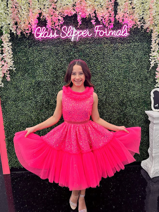 Marc Defang Kids 5111 Dress is a stunning cocktail dress for special occasions. Crafted from sequin tulle with pleated ruffle and layered detailing, it is sure to turn heads. Perfect for pageants, it will make your little one feel like a princess. Please inquire for additional colors.  Sizes: 14  Colors: Barbie pink