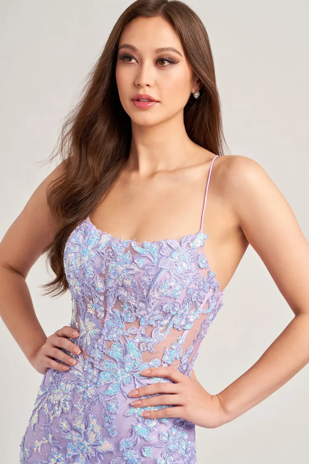 Elevate your prom look with the Ellie Wilde EW35057 dress. The sheer sequin lace corset adds a touch of elegance and the mermaid silhouette enhances your figure. With a daring slit and backless design, this dress is sure to make a statement. A scoop neck completes the look.   Sizes: 00-16  Colors: Lilac, Ice Blue
