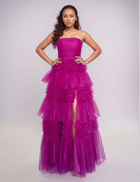 Elevate your evening with the Nina Canacci 5305 prom dress, featuring a flowing A-line silhouette crafted from layered magenta tulle. The long pleated skirt adds graceful movement, while the corset bodice offers a flattering fit and elegant structure. A daring maxi slit enhances allure, making this ballgown perfect for making a sophisticated statement at any formal event.

Size: 4

Color: Magenta