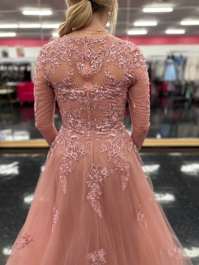 This elegant Nina Canacci 5310 dress in size 4 features a delicate rose lace design with long sleeves and a flattering A-line silhouette. Perfect for formal occasions, it showcases a high sheer lace back and a sweetheart neckline, combining classic sophistication with modern detail. Ideal for a mother of the bride or evening event, this gown offers timeless grace and refined style.

Size: 4

Color: Rose