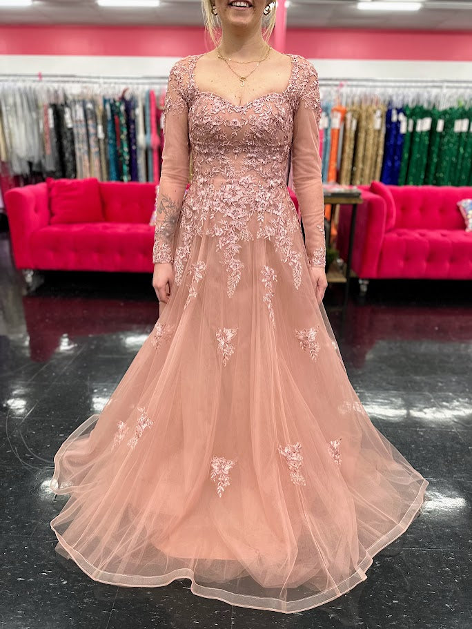 This elegant Nina Canacci 5310 dress in size 4 features a delicate rose lace design with long sleeves and a flattering A-line silhouette. Perfect for formal occasions, it showcases a high sheer lace back and a sweetheart neckline, combining classic sophistication with modern detail. Ideal for a mother of the bride or evening event, this gown offers timeless grace and refined style.

Size: 4

Color: Rose