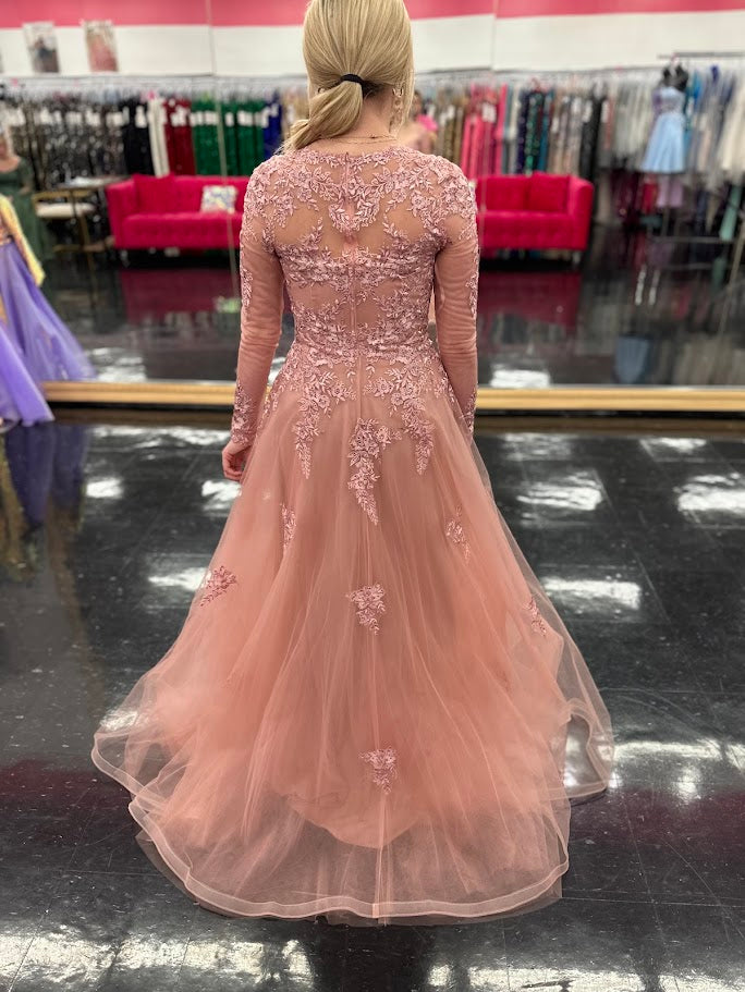 This elegant Nina Canacci 5310 dress in size 4 features a delicate rose lace design with long sleeves and a flattering A-line silhouette. Perfect for formal occasions, it showcases a high sheer lace back and a sweetheart neckline, combining classic sophistication with modern detail. Ideal for a mother of the bride or evening event, this gown offers timeless grace and refined style.

Size: 4

Color: Rose