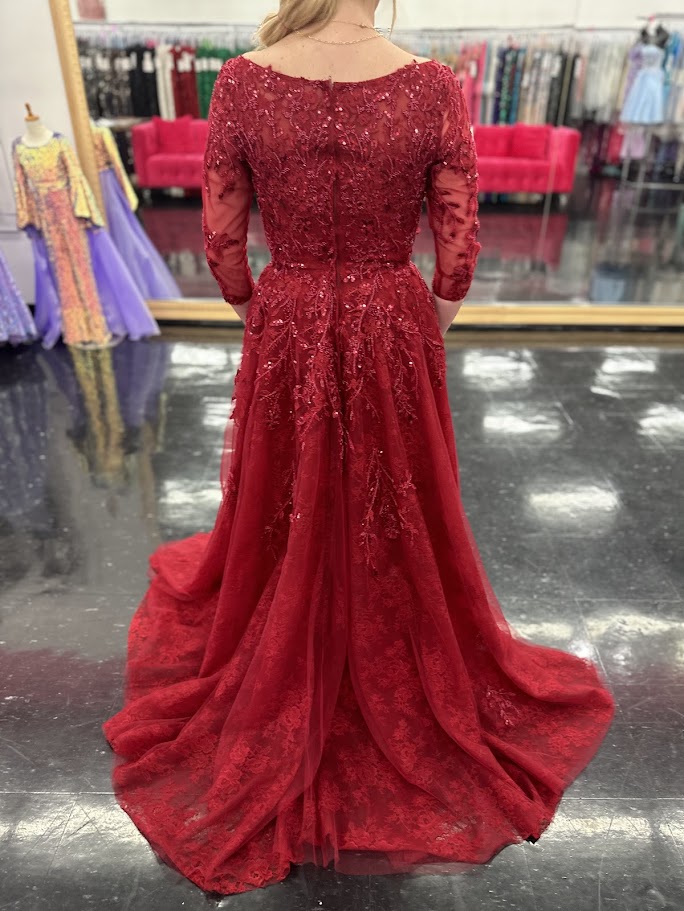 This Nina Canacci 5311 gown in size 4 features a rich lace fabric crafted into a flattering A-line silhouette. The high neckline and formal sleeves offer a polished, elegant look, while delicate beading and sequins add a subtle shimmer perfect for evening events. Ideal for mother-of-the-bride or other formal occasions, this dress combines timeless sophistication with exquisite detailing.

Size: 4

Color: Burgundy