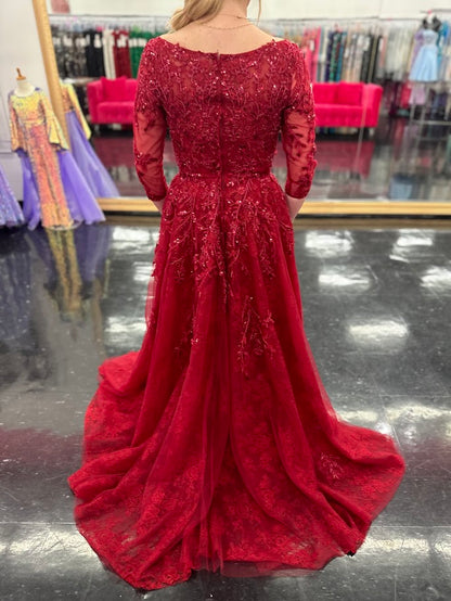 This Nina Canacci 5311 gown in size 4 features a rich lace fabric crafted into a flattering A-line silhouette. The high neckline and formal sleeves offer a polished, elegant look, while delicate beading and sequins add a subtle shimmer perfect for evening events. Ideal for mother-of-the-bride or other formal occasions, this dress combines timeless sophistication with exquisite detailing.

Size: 4

Color: Burgundy