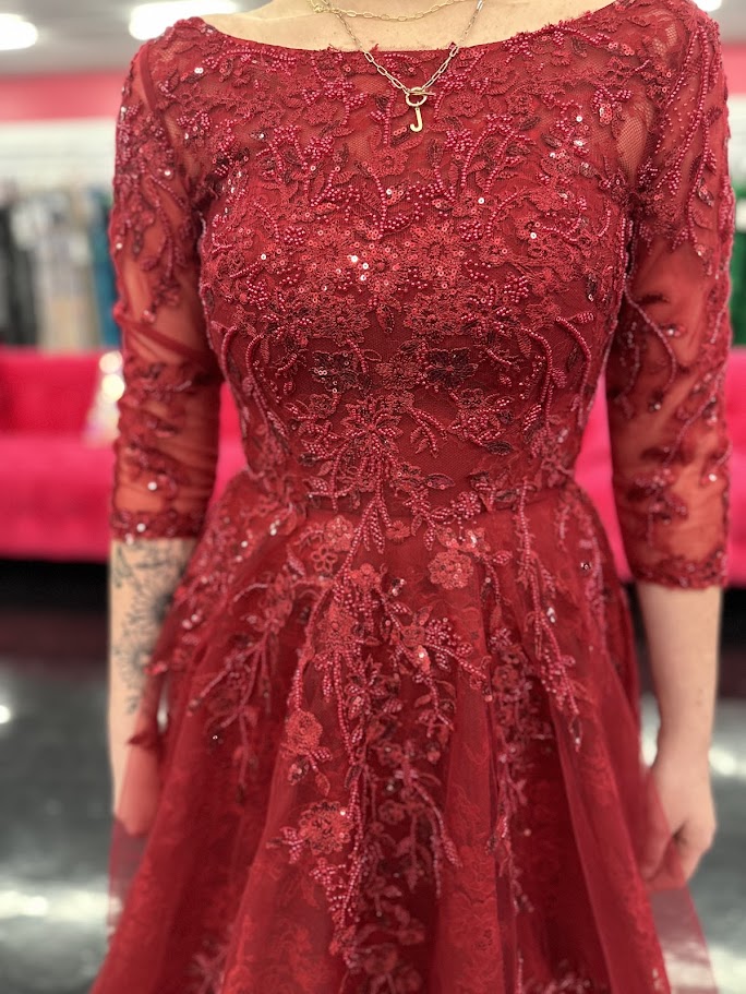 This Nina Canacci 5311 gown in size 4 features a rich lace fabric crafted into a flattering A-line silhouette. The high neckline and formal sleeves offer a polished, elegant look, while delicate beading and sequins add a subtle shimmer perfect for evening events. Ideal for mother-of-the-bride or other formal occasions, this dress combines timeless sophistication with exquisite detailing.

Size: 4

Color: Burgundy