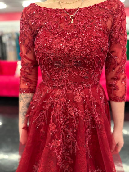 This Nina Canacci 5311 gown in size 4 features a rich lace fabric crafted into a flattering A-line silhouette. The high neckline and formal sleeves offer a polished, elegant look, while delicate beading and sequins add a subtle shimmer perfect for evening events. Ideal for mother-of-the-bride or other formal occasions, this dress combines timeless sophistication with exquisite detailing.

Size: 4

Color: Burgundy