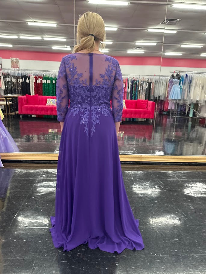 Elevate your formal occasion with the Nina Canacci 5312 gown, featuring delicate lace and chiffon fabric that gracefully drapes for a refined silhouette. The long sheer sleeves and high neckline offer elegant coverage, while crystal embellishments add a subtle sparkle, perfect for a mother of the bride or wedding guest seeking timeless sophistication.

Size: 4

Color: Purple
