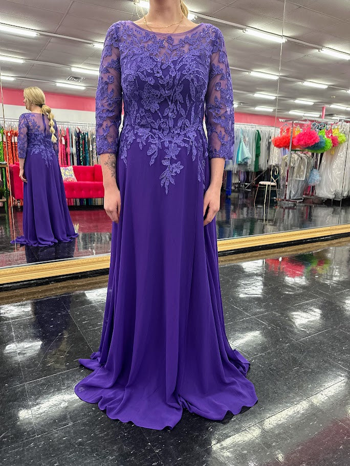 Elevate your formal occasion with the Nina Canacci 5312 gown, featuring delicate lace and chiffon fabric that gracefully drapes for a refined silhouette. The long sheer sleeves and high neckline offer elegant coverage, while crystal embellishments add a subtle sparkle, perfect for a mother of the bride or wedding guest seeking timeless sophistication.

Size: 4

Color: Purple