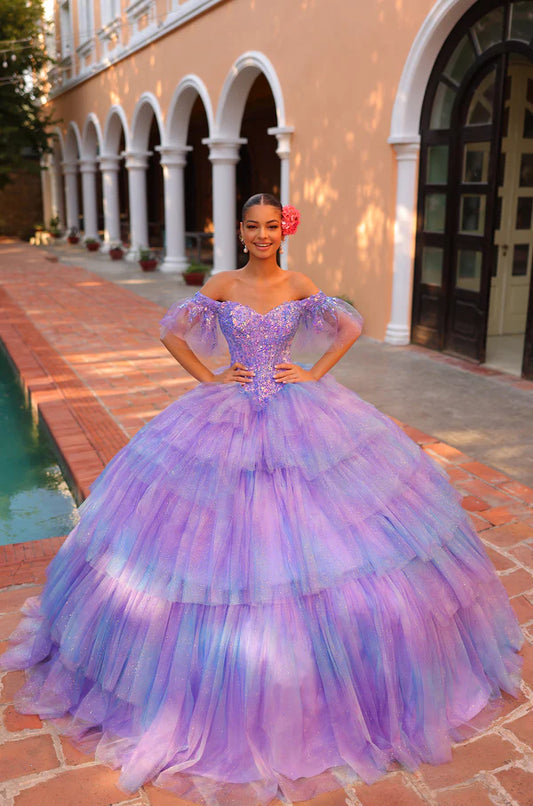 Elevate your Quinceañera look with the stunning Amarra 54312 dress. Featuring a layered tulle ball gown with a shimmering sequin bodice and an off-the-shoulder neckline, this dress will make you shine on your special day. The ombre corset adds a touch of glamour, making you the belle of the ball.&nbsp;