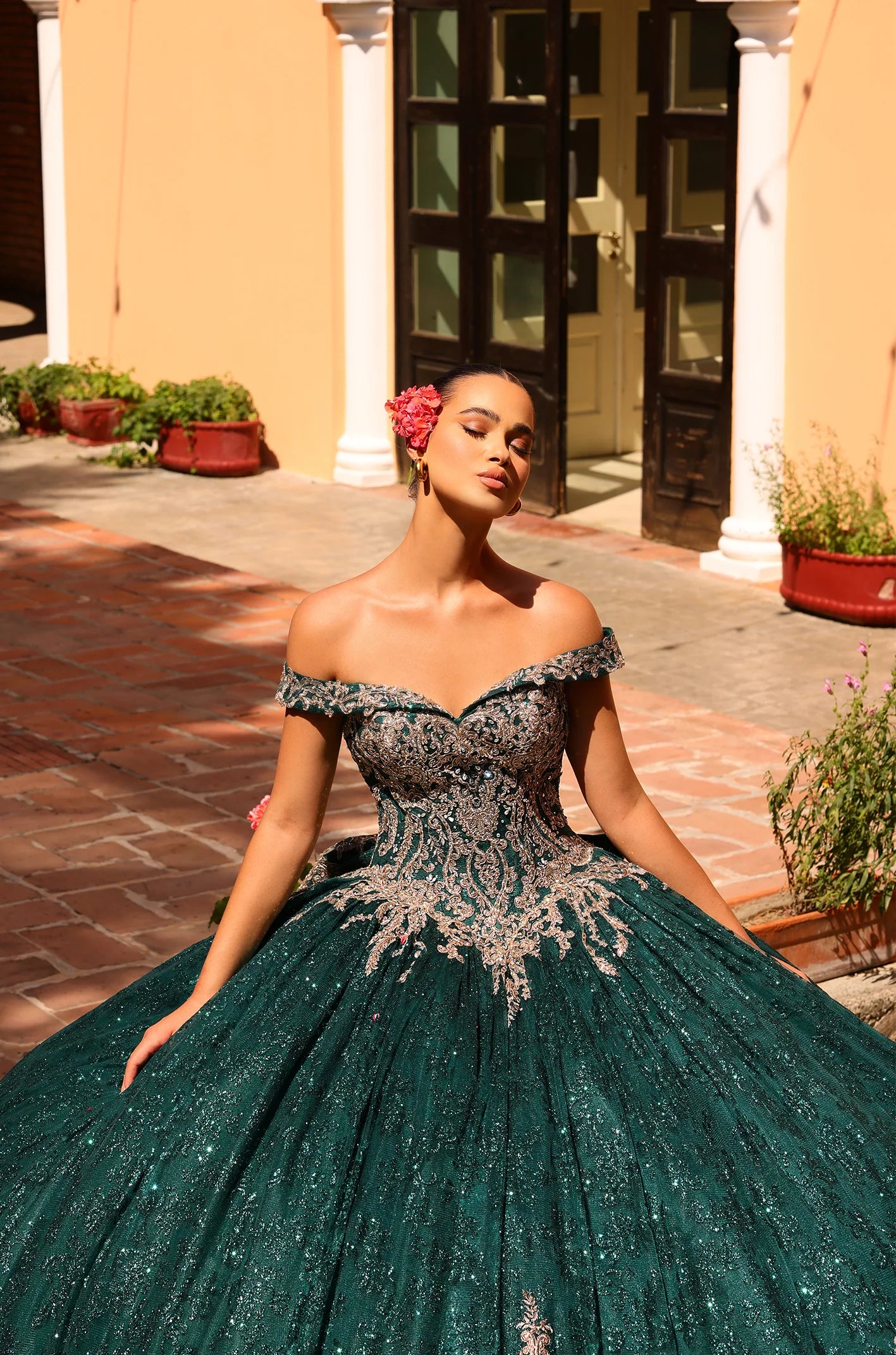 This Amarra 54324 Quinceanera Dress boasts a glittering hooded cape and off-the-shoulder corset, perfect for making a grand entrance at any party or ball. The exquisite train and bow detail add an extra touch of elegance to this stunning gown. Elevate your style with this eye-catching dress.