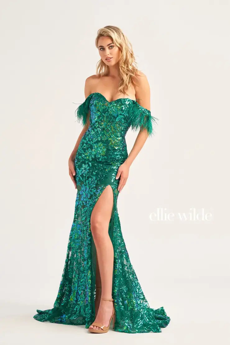 The Ellie Wilde EW34034 is a glamorous formal gown featuring an off-the-shoulder neckline, corset bodice, and a full-length sheer sequin skirt with a side slit. Festooned with a beautiful feather trim, this dress is sure to make a statement.  Sizes: 00-16  Colors: ORANGE, ROYAL BLUE, LILAC, HOT PINK, SAPPHIRE, SKY BLUE, EMERALD, PURPLE RAIN
