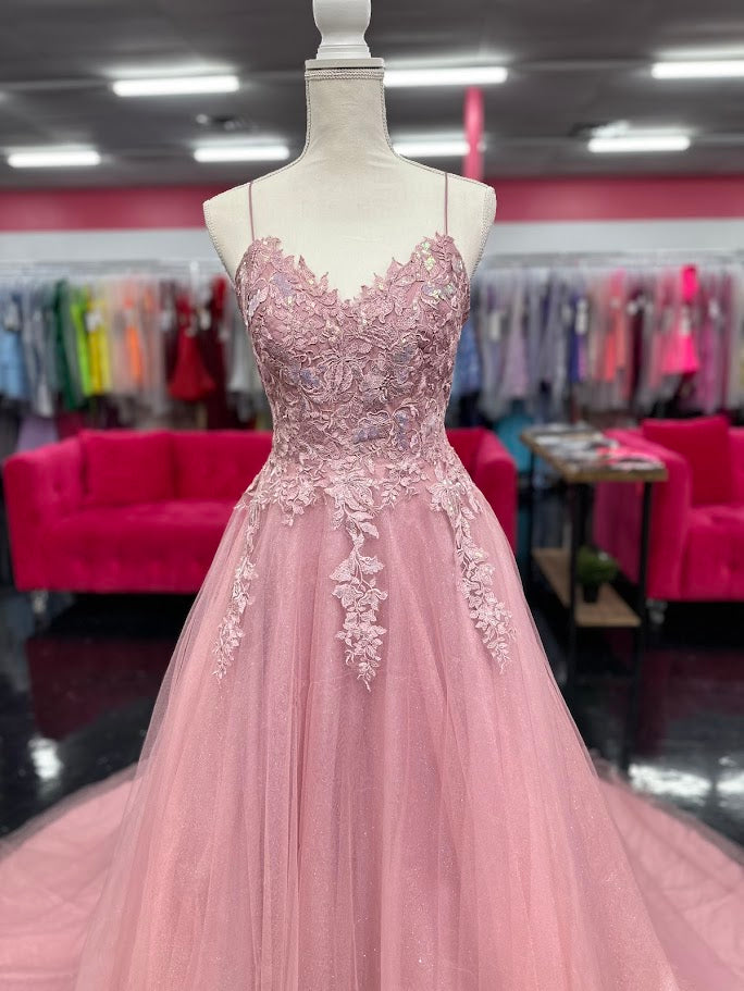 Expertly crafted by Nina Canacci, the 6624 Long A Line dress features a flattering corset bodice and a stunning backless design. The elegant train and A-line silhouette make it the perfect choice for prom, pageants, or any formal event. Elevate your style with this timeless and beautifully designed gown.

Sizes: 4

Colors: Mauve