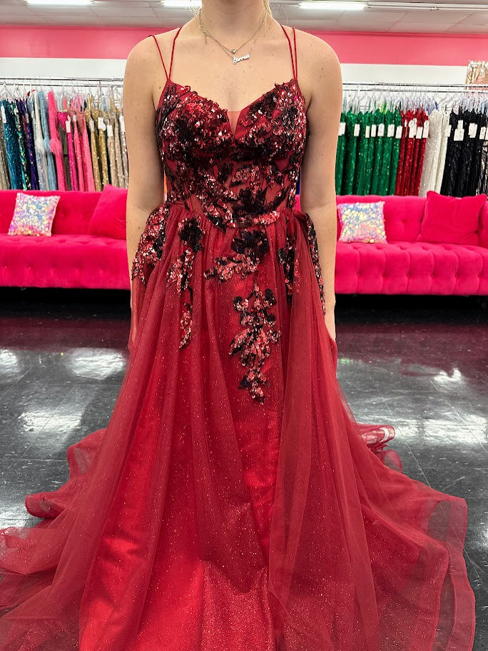 Elevate your evening with the Nina Canacci 6630, a size 4 burgundy gown that exudes elegance. This A-line dress features a shimmering sequin overlay and a daring maxi slit, complemented by a structured corset and a detachable side overskirt for added drama. Perfect for formal occasions, it combines classic sophistication with a modern edge to ensure you stand out gracefully.

Sizes: 4

Colors: Burgundy