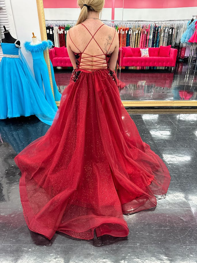 Elevate your evening with the Nina Canacci 6630, a size 4 burgundy gown that exudes elegance. This A-line dress features a shimmering sequin overlay and a daring maxi slit, complemented by a structured corset and a detachable side overskirt for added drama. Perfect for formal occasions, it combines classic sophistication with a modern edge to ensure you stand out gracefully.

Sizes: 4

Colors: Burgundy