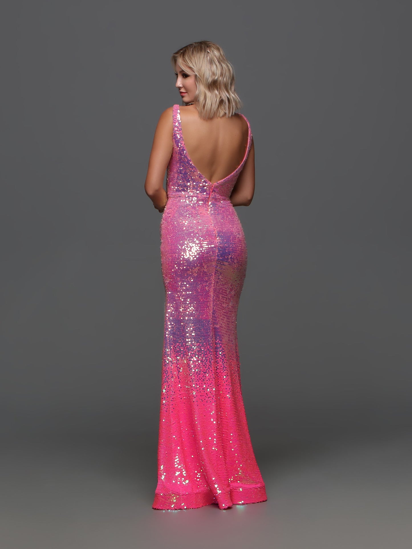 Introducing the Candice Wang 72301 Long Pink Sequin Ombre Prom Dress, the perfect combination of elegance and glamour. This stunning gown features a V-neckline and a subtle slit, making it a classic yet bold choice for any formal occasion. With its ombre sequin design, you'll shine and stand out from the crowd. Make a statement and feel confident in this eye-catching dress.  Sizes: 0-20  Colors: Bubblegum