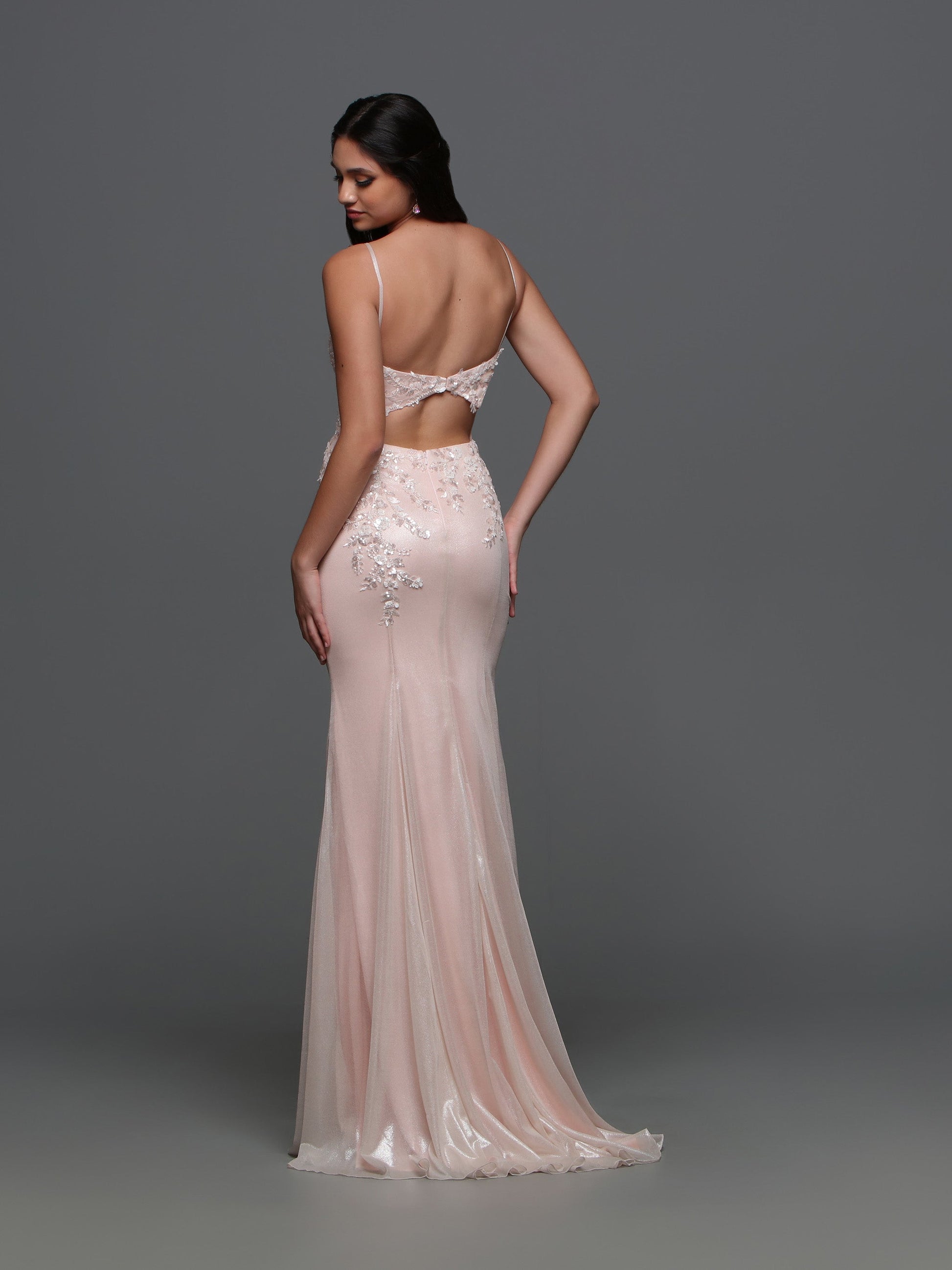 This Candice Wang evening gown style 72331 exudes elegance and sophistication. With its fitted silhouette and metallic shimmer, it will make you stand out at any formal event. The lace, beaded sequin details and cutout back add a touch of glamour. Perfect for prom or any special occasion.  Sizes: 0-10  Colors: Ice Pink, Lavender