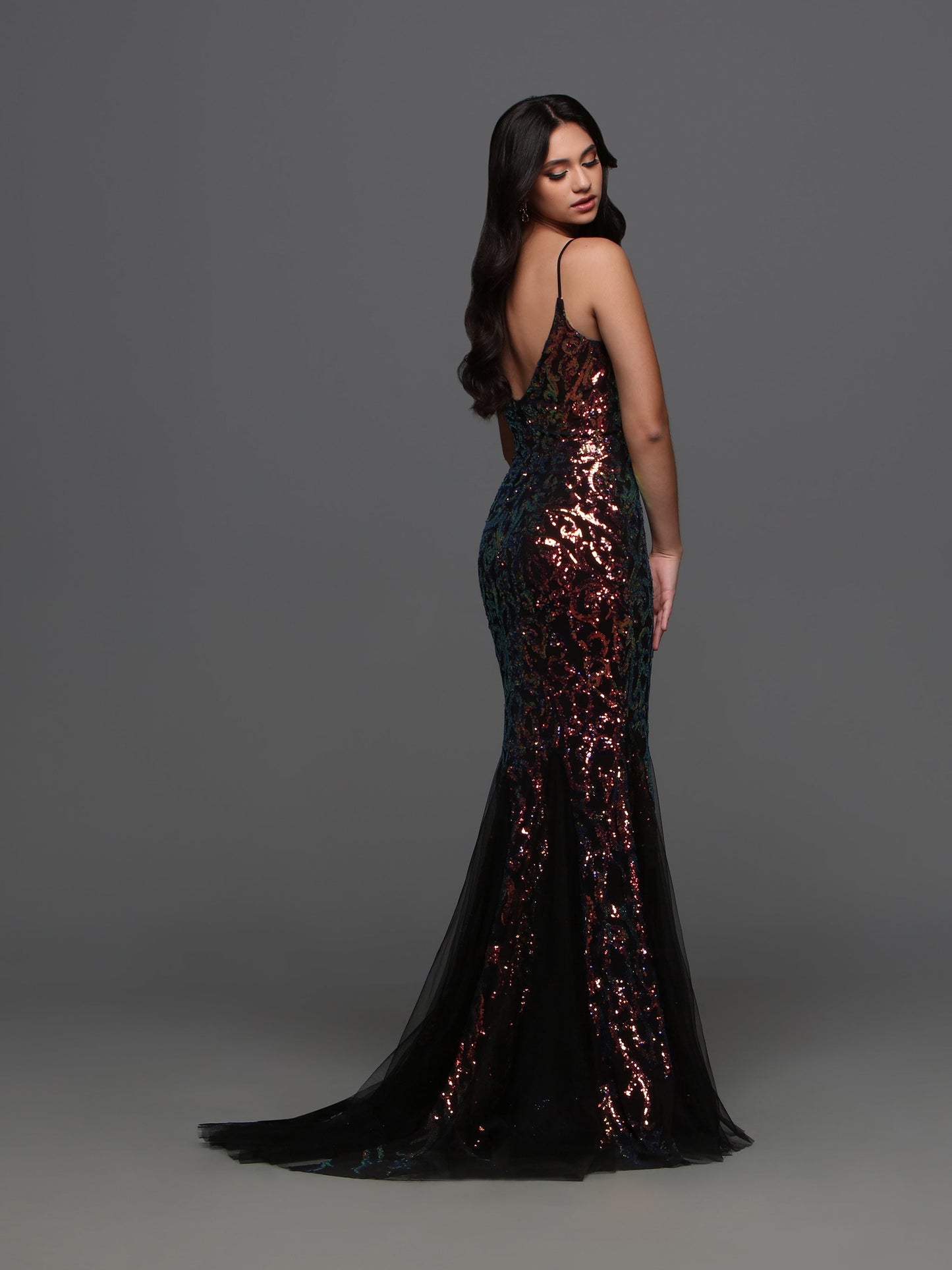 Crafted by designer Candice Wang 72338, this stunning evening gown features a sheer corset top with intricate sequin detailing. The tulle gusset and mermaid trumpet skirt add a touch of elegance and sophistication to any formal event. Be the belle of the ball in style and comfort.  Sizes: 0-12  Colors: Black Magic, Hot Pink