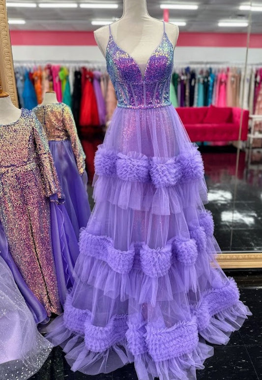The Candice Wang 72377 Sequin V Neck Prom Dress features a fitted sequin silhouette with a stunning sequin V-neck corset bodice. The Detachable pleated tulle skirt adds layers for a full and luxurious look. Perfect for prom or any special occasion.  Sizes: 4, 10  Colors: Purple