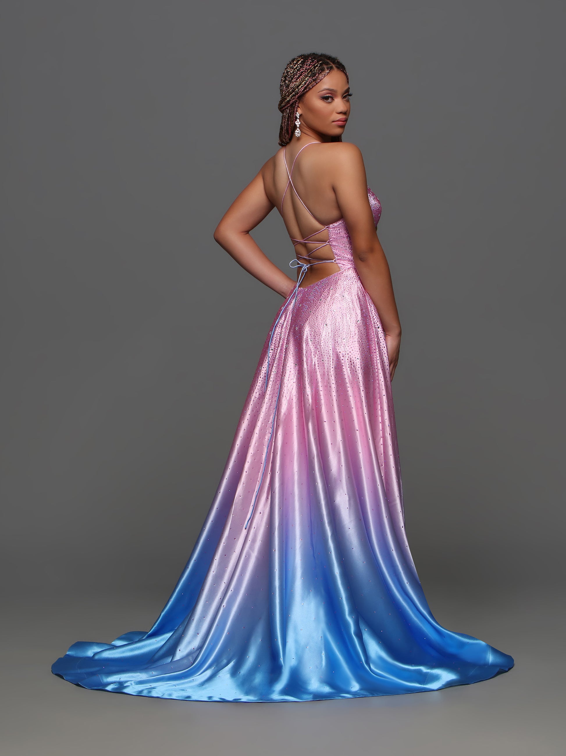 Elevate your prom style with the Candice Wang 72386 Pink Ombre A Line Maxi Slit Prom Dress. The backless design and corset detailing flatter your figure, while the crystal embellishments add a touch of glamour. The ombre color scheme creates a unique and stylish look.  Sizes: 0-16  Colors: Pink Ombre