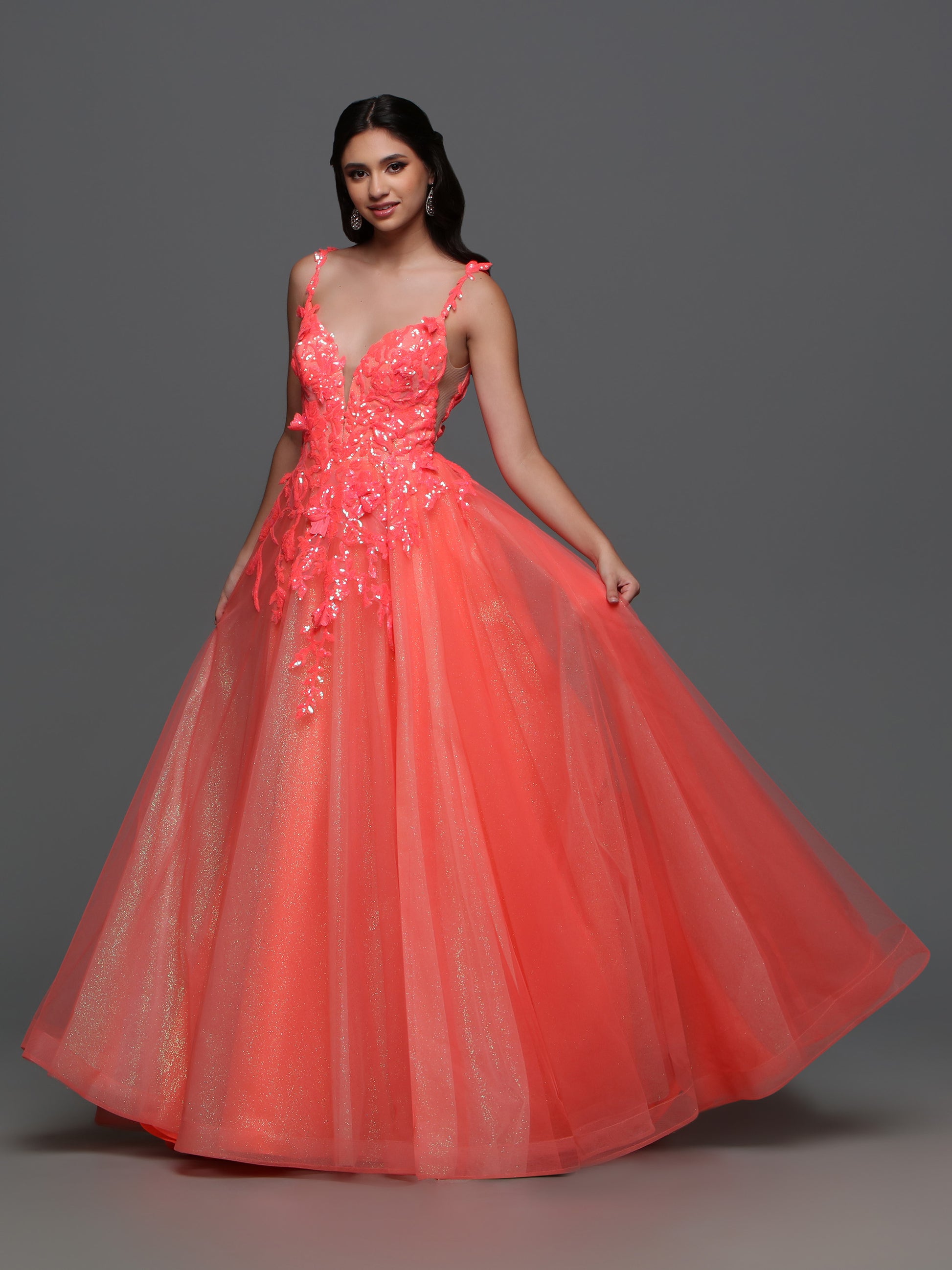 Elevate your formal look with the Candice Wang 72388 Long Shimmer Sequin Ballgown Prom Dress. The A-line silhouette and Glitter tulle details are complemented by the shimmering sequin lace, giving you an undeniable sparkle. Make a statement at your next event with this elegant and stylish dress.  Sizes: 0-20  Colors: Coral 