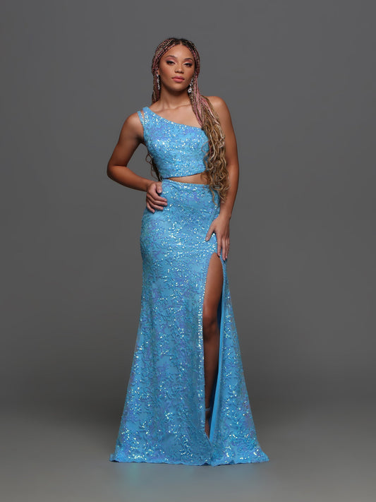 Dazzle the crowd in the Candice Wang 72389 Prom Dress. Featuring an alluring one shoulder design with intricate sequin cutouts, this gown exudes elegance and glamour. The thigh-high slit and train add a touch of drama to this formal dress. Perfect for standing out at prom or any special occasion.  Sizes:: 0-20  Colors: Blue