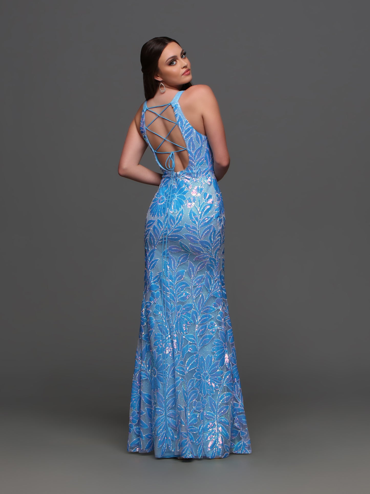 Step into the spotlight with the Candice Wang 72404 Shimmer Sequin High Neck Prom Dress. The backless corset design and high neckline create a stylish and elegant look, while the shimmering sequins add a touch of glamour. The slit gown ensures comfort while dancing the night away. Perfect for making a statement at prom or any special occasion.  Sizes: 0-16  Colors: Blue, Neon Pink