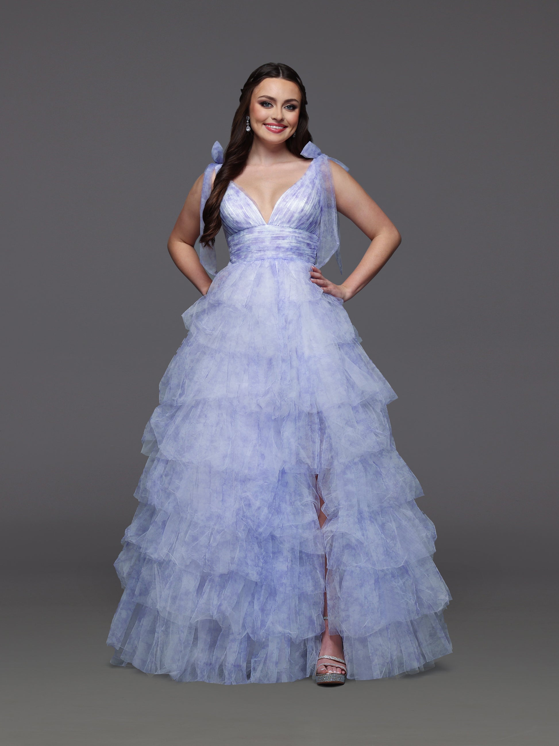 Step into elegance with the Candice Wang 72472 ballgown, designed in a delicate lavender and ivory palette. This size 2 dress features layered ruffles and a charming bow print that add a whimsical touch to your formal look. The flowing silhouette and tasteful slit offer both grace and comfort, making it perfect for prom or any special occasion where you want to stand out beautifully.

Size: 2

Color: Lavender/Ivory