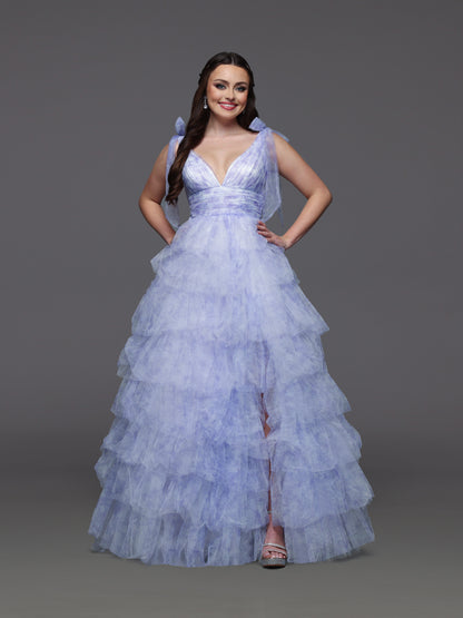 Step into elegance with the Candice Wang 72472 ballgown, designed in a delicate lavender and ivory palette. This size 2 dress features layered ruffles and a charming bow print that add a whimsical touch to your formal look. The flowing silhouette and tasteful slit offer both grace and comfort, making it perfect for prom or any special occasion where you want to stand out beautifully.

Size: 2

Color: Lavender/Ivory
