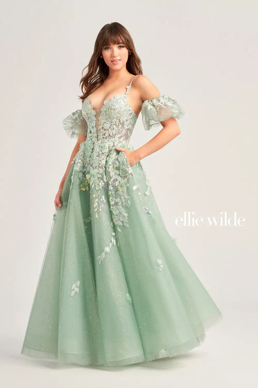 The Ellie Wilde EW35205 Prom Dress combines sheer sequin lace with a corset top and A-line silhouette, creating a stunning and shimmering gown. The puff sleeves add a touch of glamour, making this dress perfect for any prom or formal event. Pockets  Sizes: 00-20  Colors: Sage, Ice Blue