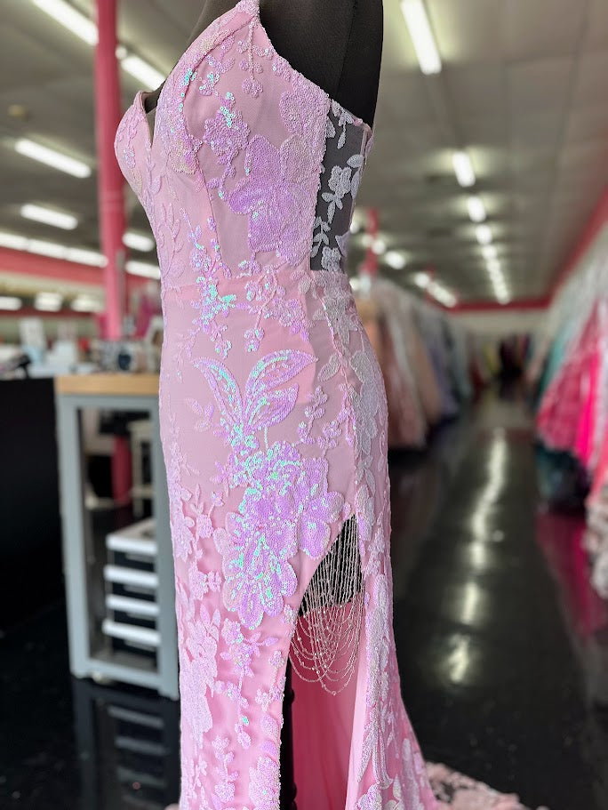 Elevate your evening with the Nina Canacci 7611, a size 4 fitted prom dress in delicate pink. This gown features intricate sequin lace, beaded fringe accents, and a sheer lace slit that adds a touch of allure. Designed to flatter your silhouette, it combines elegance and modern sophistication for unforgettable formal occasions.

Size: 4

Color: Light Pink