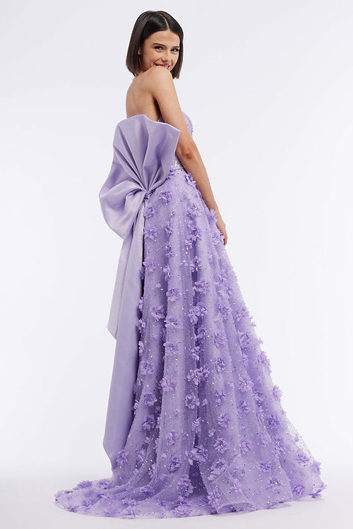 Elevate your formal look with the Vienna Prom 7891 Long Prom Dress. Featuring a strapless design, large back bow, and 3D floral embellishments, this gown exudes elegance and sophistication. With a sheer train for added drama, this dress is perfect for proms, pageants, and formal events.