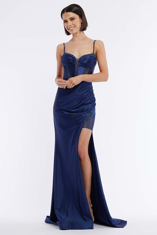 The Vienna Prom 7960 is an elegant evening gown featuring a long satin skirt, ruched bustier corset, and a dazzling crystal bodice – the perfect look for any pageant or formal occasion. The maxi slit design gives a subtle hint of sexiness that won't overpower the sophistication of this classic silhouette.