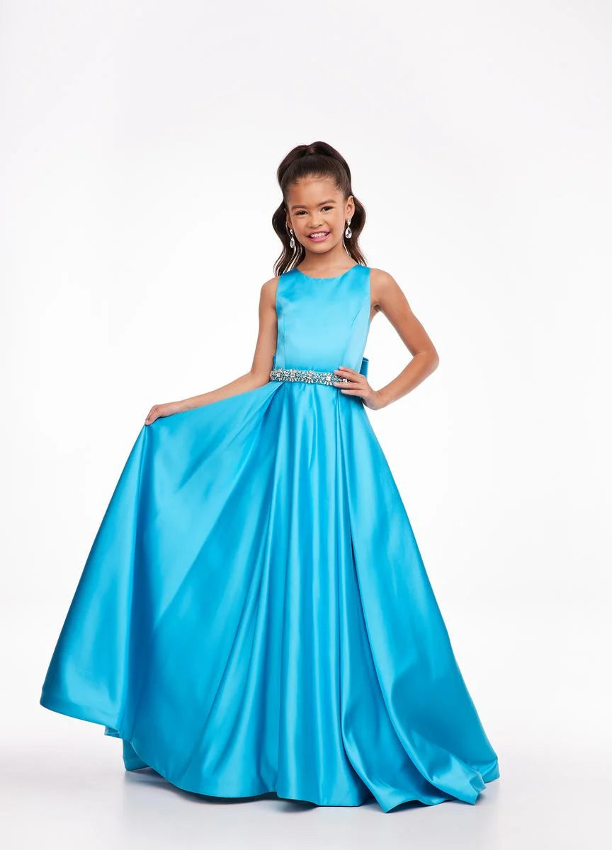 This Ashley Lauren 8079 Size 12 Ivory Long satin A Line girls Pageant Dress features an elegant crew neckline, a crystal encrusted waistline, and an A-line skirt that is complemented by a detachable bow at the back. Perfect for formal occasions, this high-quality gown will make your little girl look beautiful.  Size: 12  Color: Ivory