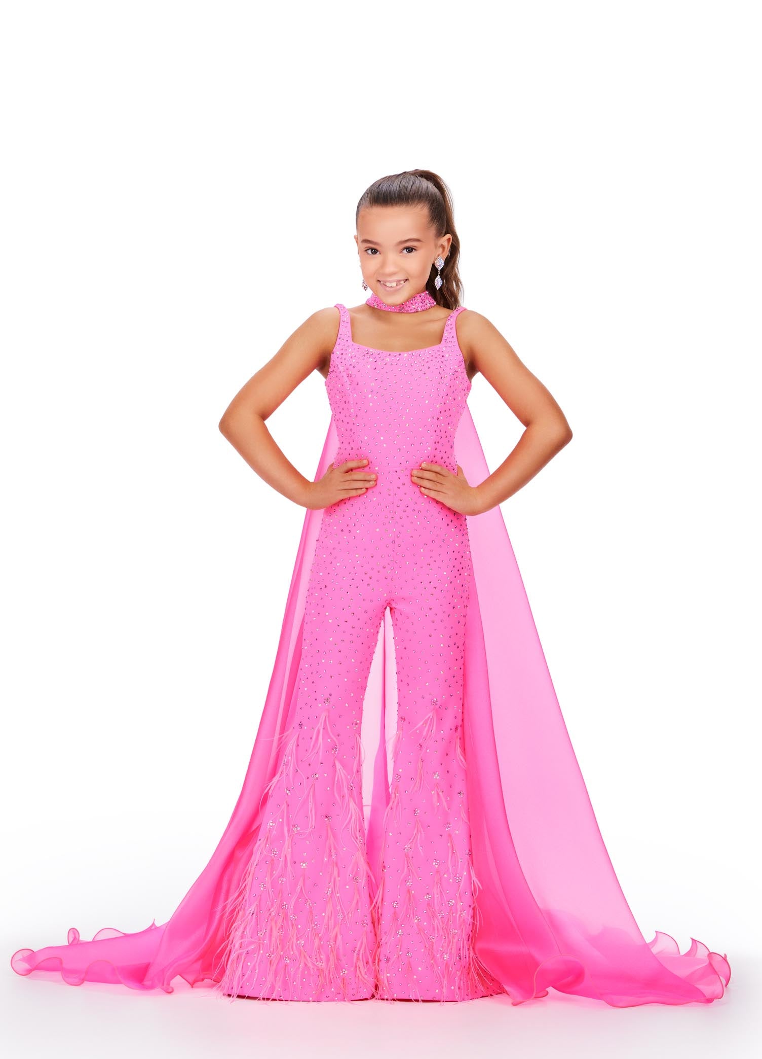 Ashley Lauren Kids 8210 Long Girls Pageant Jumpsuit with Crystal embellishments and a scoop neckline. Feather Embellished flared Bell Bottoms with a choker embellished with crystals and organza Cape. Feel like a popstar in this stunning jumpsuit! Covered in sparkly press on stones, this jumpsuit has a detached choker and organza cape. With feathers cascading down the pants, this jumpsuit is going to make a statement!  Sizes: 4-16  Colors: Aqua, Hot Pink, Red
