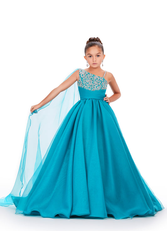 This Ashley Lauren Kids 8212 one-shoulder girls' pageant dress is both elegant and fun. With a cape design and crystal embellishments, this A-line ball gown is perfect for any pageant or special occasion. Look and feel like a princess in this stunning dress. This gorgeous organza ball gown is meant for a future queen! Featuring a stunning beaded bustier and one shoulder cape, this gown is sure to stun!