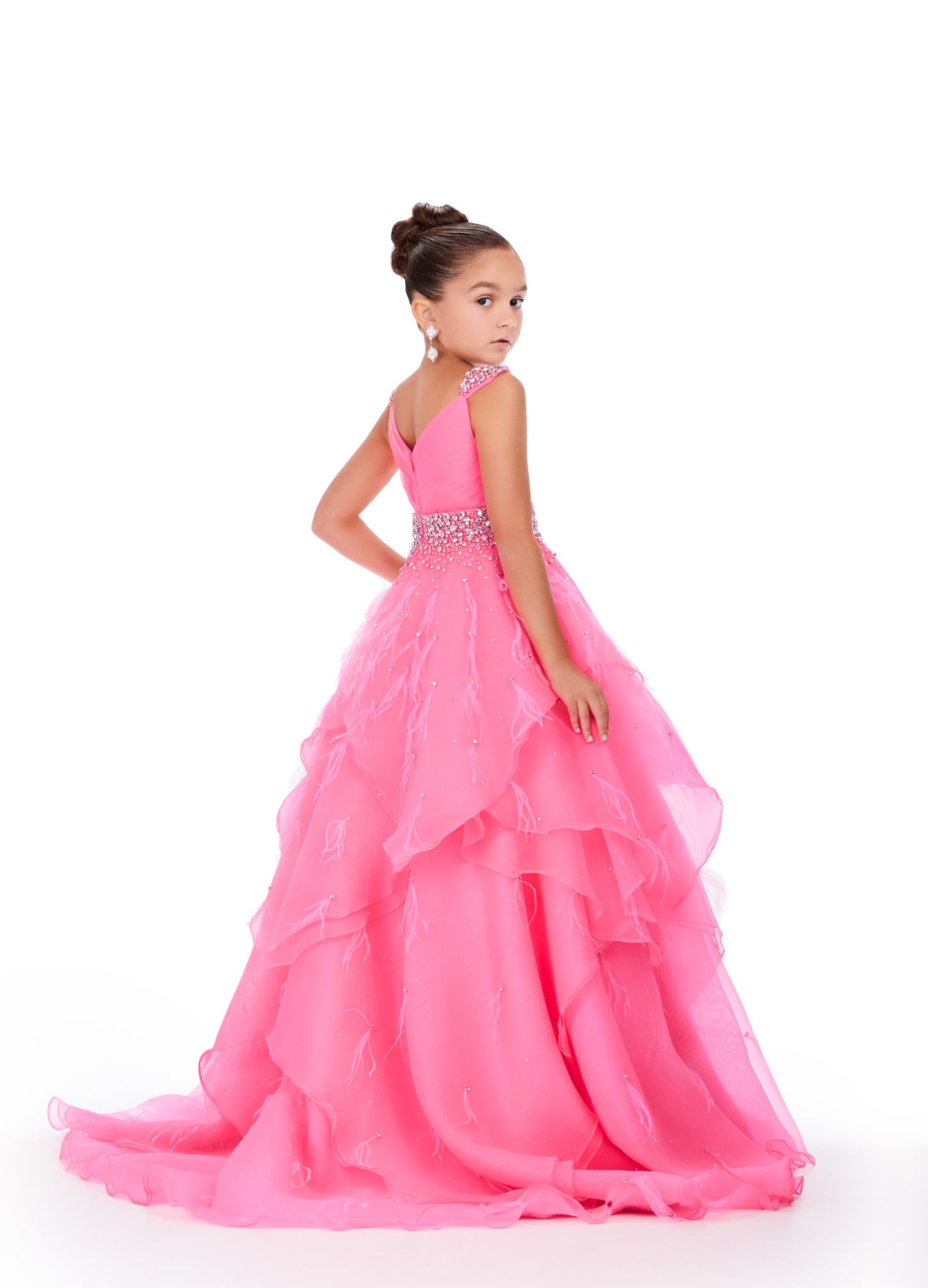 Elevate your little one's pageant look with the Ashley Lauren Kids 8219 Girls Layered Feather Pageant Dress. This stunning ballgown features a V-neck embellished with feathers, adding a touch of glamour to the overall design. With its layered skirt, this dress will make your child feel like a princess on stage. Be the star of the show in this fabulous organza ball gown