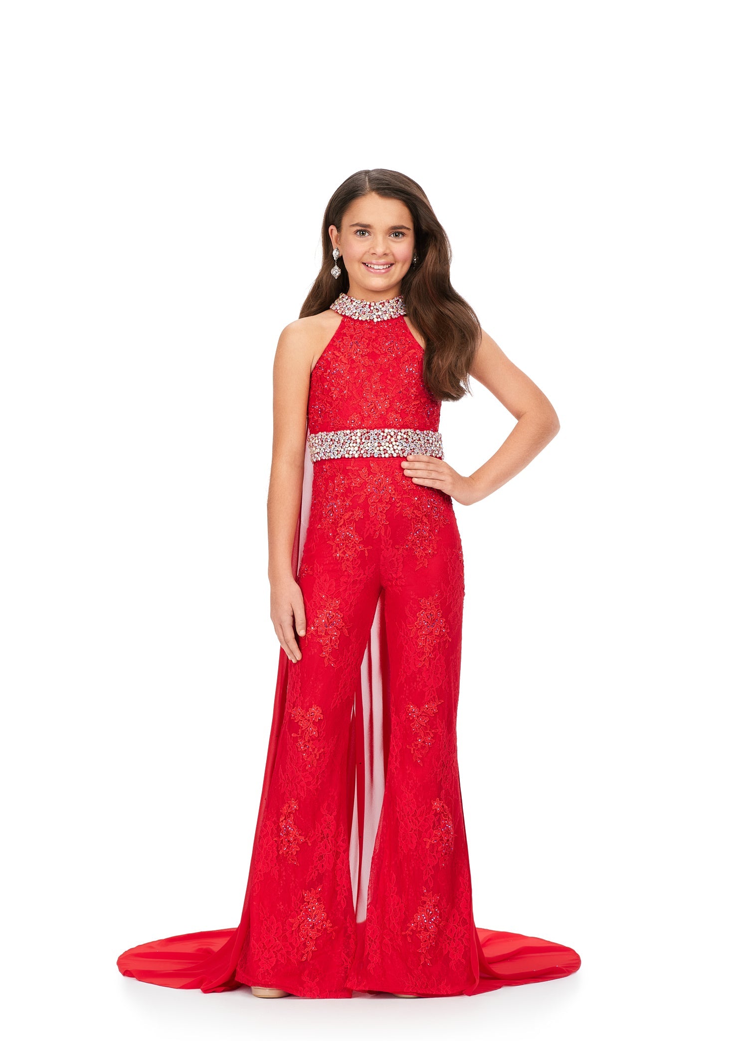 This Ashley Lauren Kids 8225 Girls Lace Crystal Jumpsuit Cape Bell Bottom Pageant Fun Fashion Wear is the perfect way to show off your sense of style. Its exquisite halter neckline and beaded accents make it a truly eye-catching piece. The chiffon cape and flare pant legs add a dramatic element and the jeweled belt and choker provide a touch of sparkle. Make a bold fashion statement with this beautiful jumpsuit!  Sizes: 4-16  Colors: Blue, Pink, Red