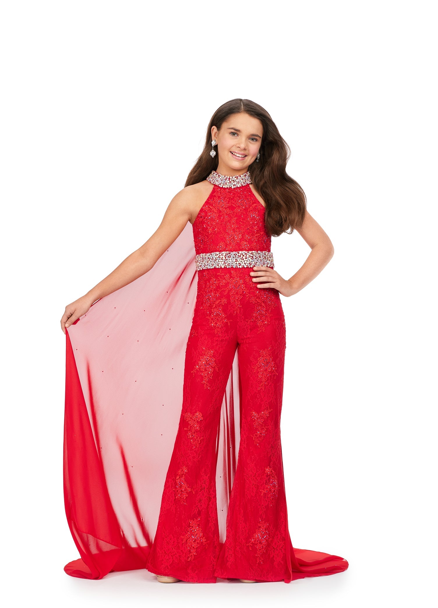 This Ashley Lauren Kids 8225 Girls Lace Crystal Jumpsuit Cape Bell Bottom Pageant Fun Fashion Wear is the perfect way to show off your sense of style. Its exquisite halter neckline and beaded accents make it a truly eye-catching piece. The chiffon cape and flare pant legs add a dramatic element and the jeweled belt and choker provide a touch of sparkle. Make a bold fashion statement with this beautiful jumpsuit!  Sizes: 4-16  Colors: Blue, Pink, Red