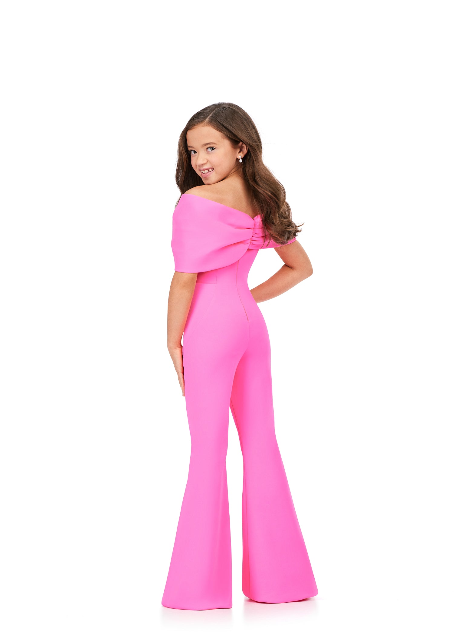 She'll be the talk of the town in the Ashley Lauren Kids 8227 Jumpsuit. Crafted from scuba material, this fashionable design features an off-shoulder bodice with an oversized bow and flare pant legs for a modern touch. Perfect for any special occasion.  Sizes: 4-16  Colors: Red, Hot Pink, Turquoise, White/Black