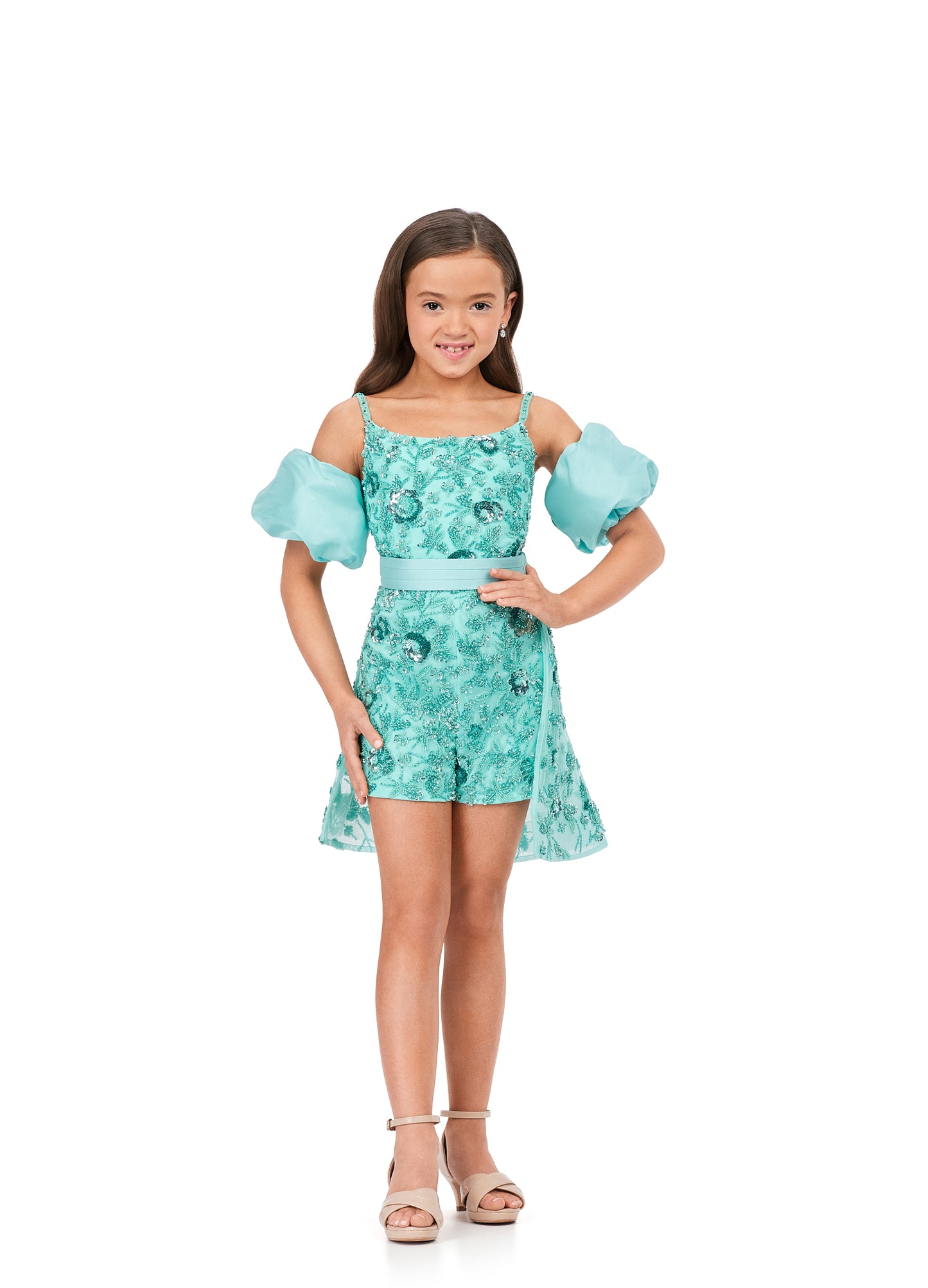Ashley Lauren Kids 8233 Fully Beaded Spaghetti Straps With Detachable Puff Sleeves Detachable Overskirt Romper. Have the most fun in this beaded romper complete with detachable puff sleeves and an overskirt!