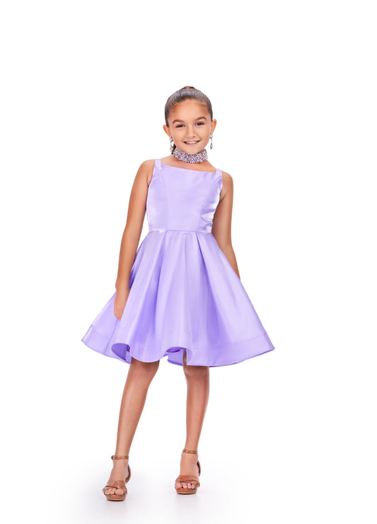 This satin formal pageant dress, designed by Ashley Lauren Kids, exudes elegance with its shimmering fabric and dazzling crystal choker neckline. Perfect for any formal occasion, this dress is sure to make your little girl feel like a princess. This sweet and sassy kids cocktail dress features a scoop neckline and a full A-Line skirt. The look is complete with a pearl & crystal encrusted choker.